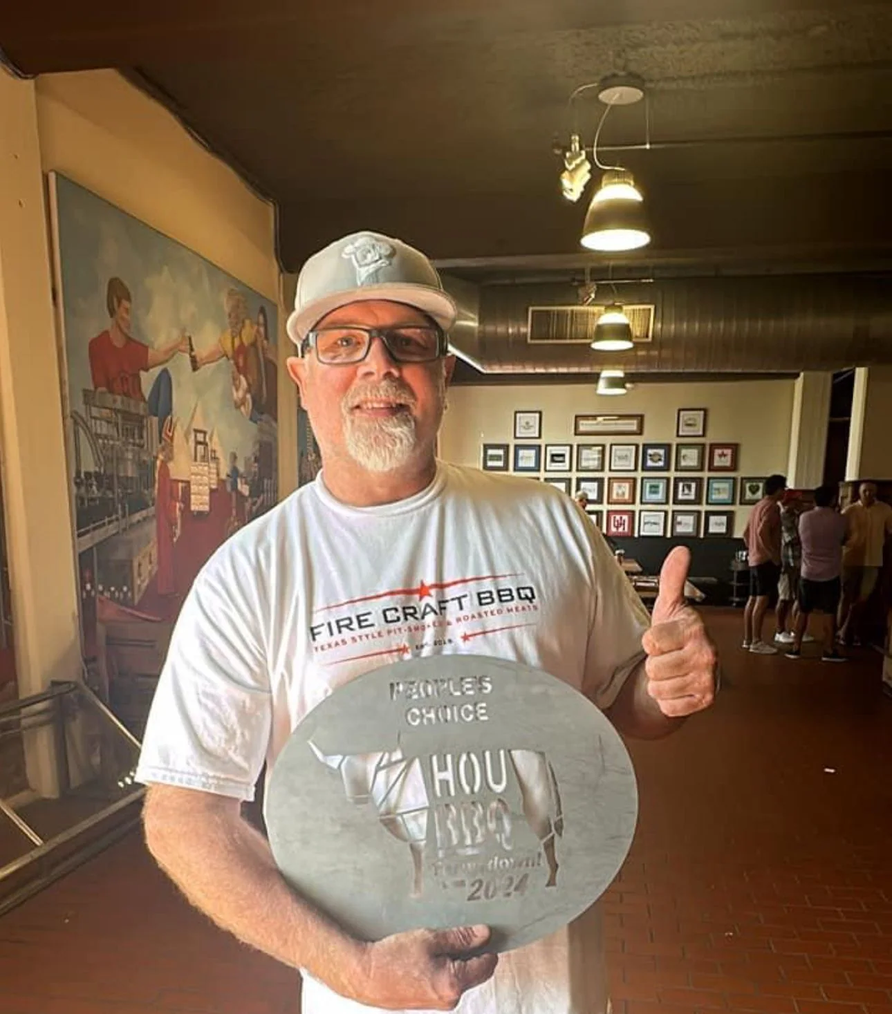 Chef David Welch holding a People’s Choice award inside Fire Craft