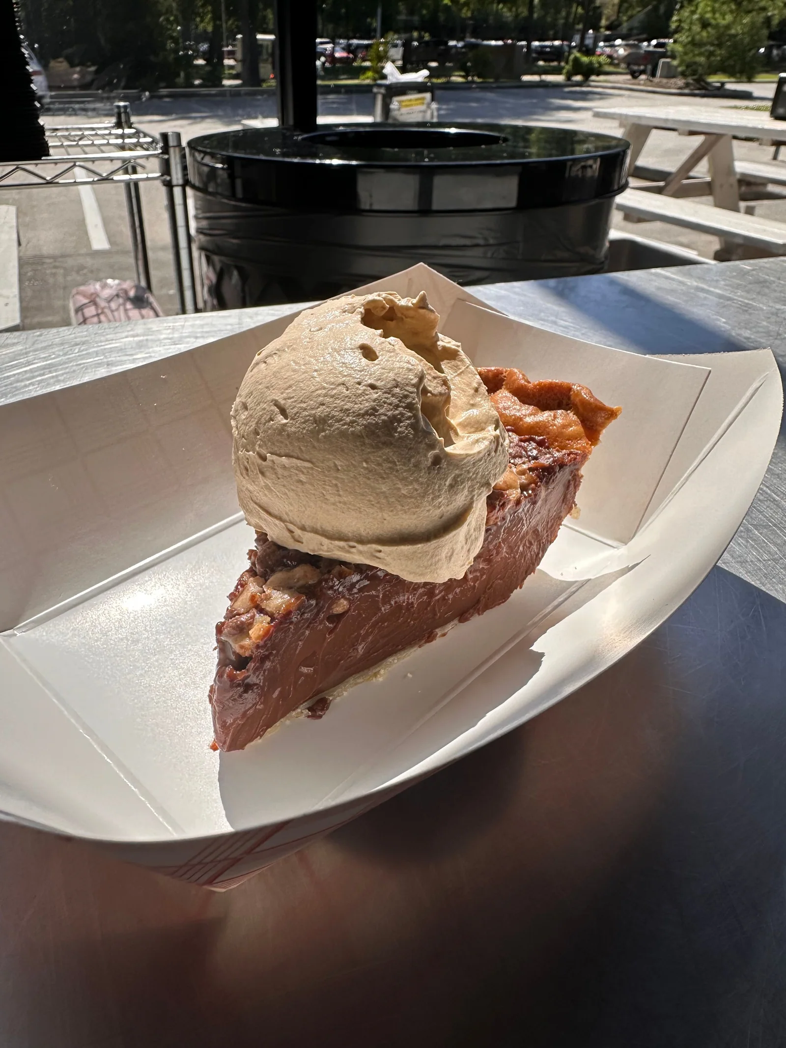 A slice of pie topped with a scoop of ice cream